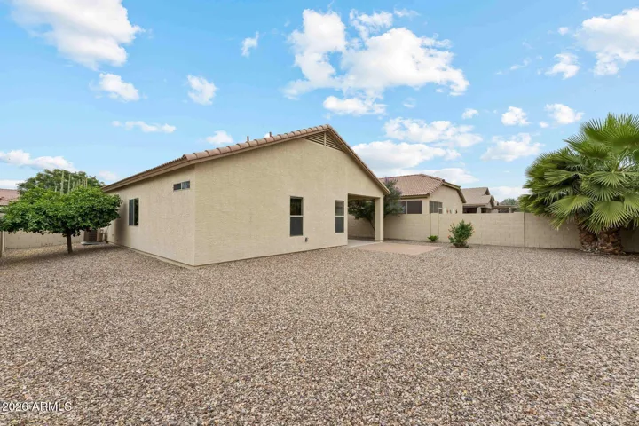 Large corner lot with Grapefruit tree, and mature palm trees.