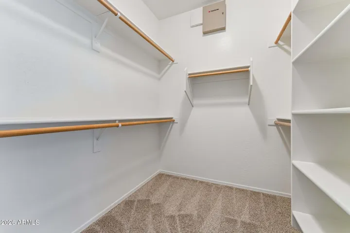 Master bedroom walk-in closet with shelving. New carpet and paint.