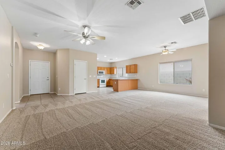 Front door, hall closet, and kitchen in this open floorplan.