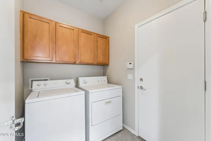 Laundry room with cabinets and garage access. Washer and Dryer.