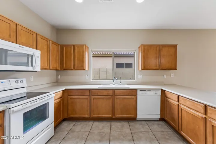 Bright kitchen with wood cabinets and pull-out shelving.