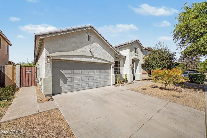Front of home showing side gate and walkway