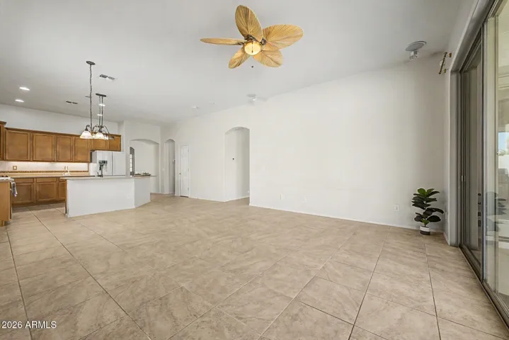 Family Room with view of Pantry, Hall to bedroom/laundry wing and etry to Primary Suite