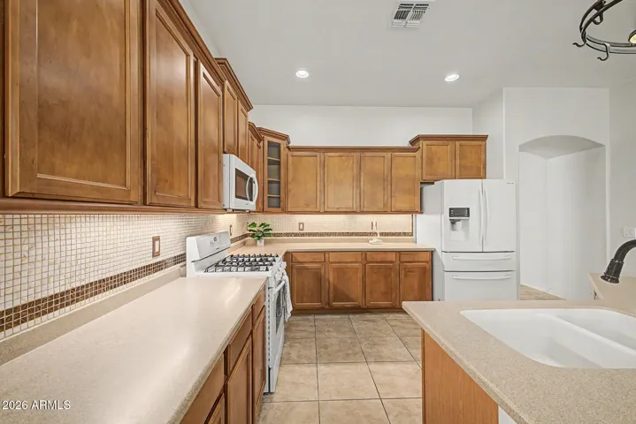 Kitchen with newer appliances and stacked cabinetry