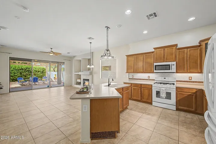 Large, ope kitchen looks over family room with stacked cabinetry!