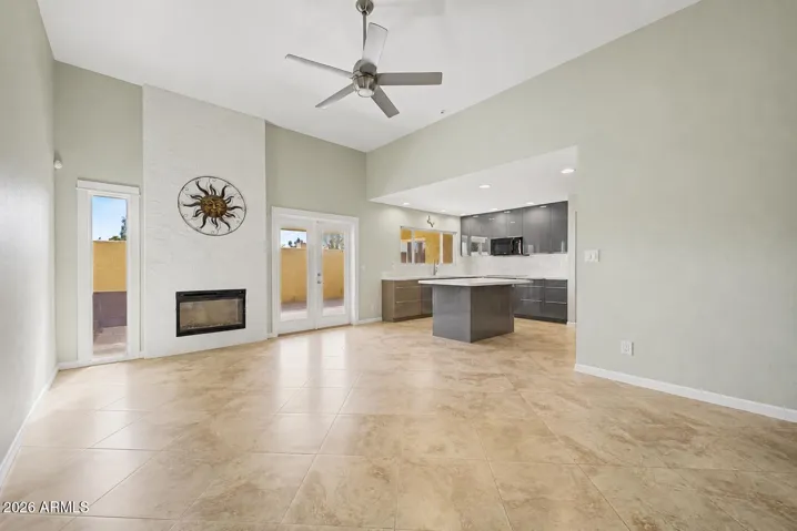 LIVING ROOM + OPEN KITCHEN + FIREPLACE VIRTUALLY DE-STAGED