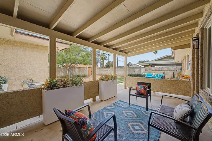 Expansive covered outdoor space ideal for Arizona living with plenty of room for gatherings, dining, and year-round enjoyment.