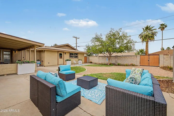 Large backyard featuring mature landscaping, grassy play areas, RV gate access, and multiple entertaining spaces.