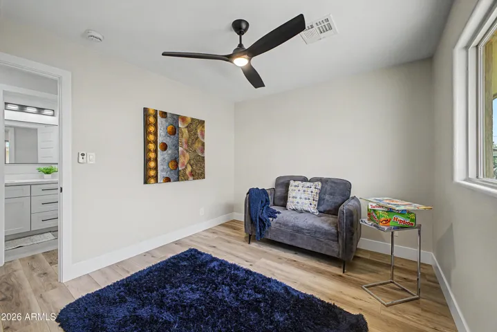 Versatile bedroom space with modern finishes, oversized window, and flexible layout perfect for guests or a home office.