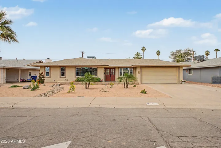 Charming single-level exterior with a spacious driveway, desert landscaping, and a welcoming covered entry that creates inviting curb appeal.