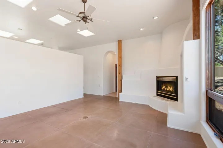 Gas Fireplace with stained concrete floors and skylights