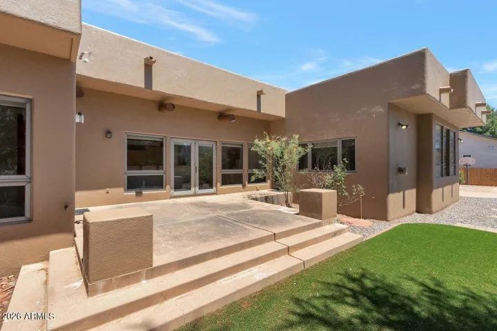 Back patio with synthetic grassy area