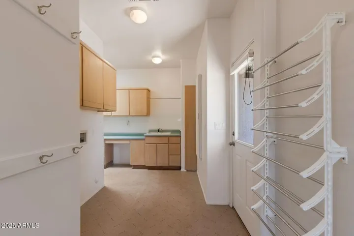 Oversize laundry room with build-in desk and cabinets