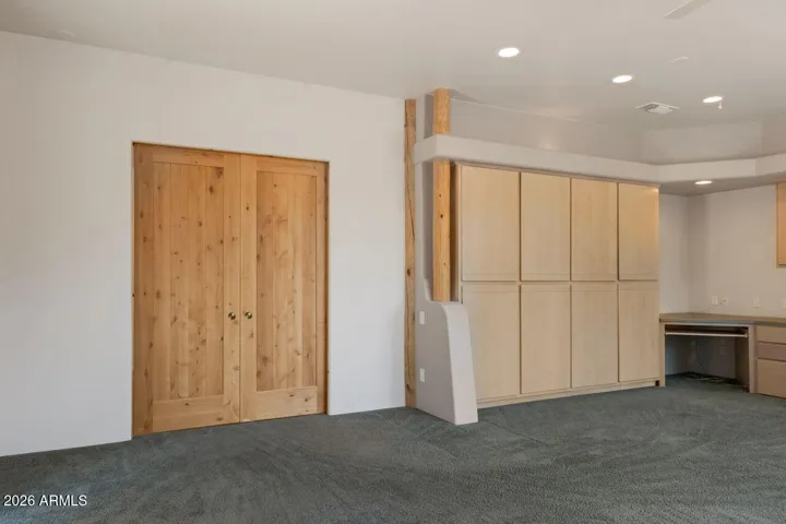Solid wood pocket doors separating family room from sitting area off kitchen