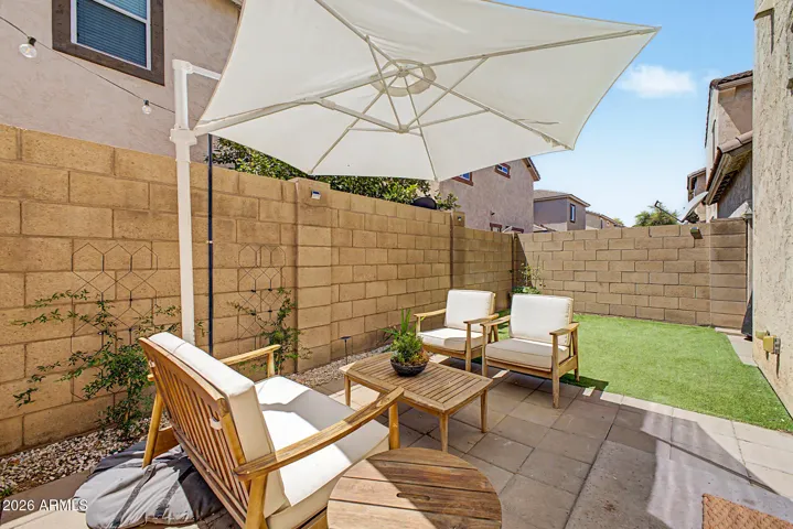 Low maintenance backyard with synthetic grass and raised garden