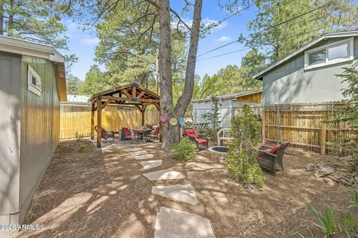 Flagstone path to wooden pergola.