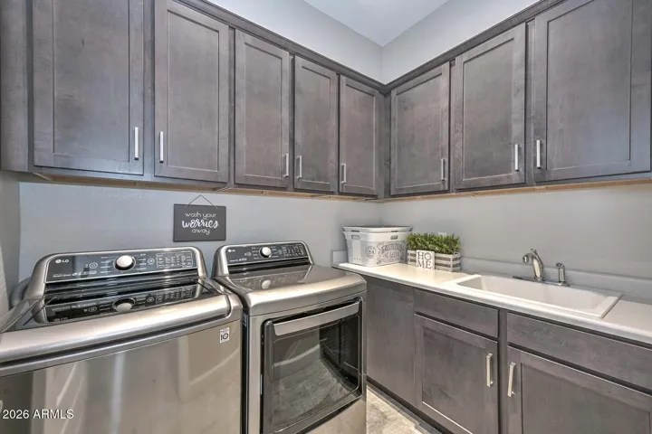 Beautiful upgraded laundry cabinets and utility sink
