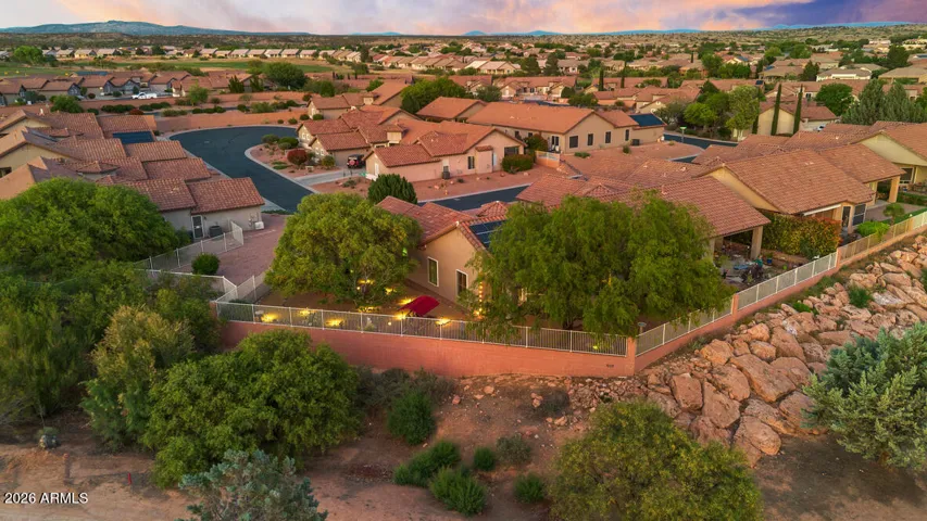 Set on a premium corner lot, the property opens to a beautifully landscaped, fully fenced yard with mature trees, soft ambient lighting, and a sense of space that feels both expansive and serene.
