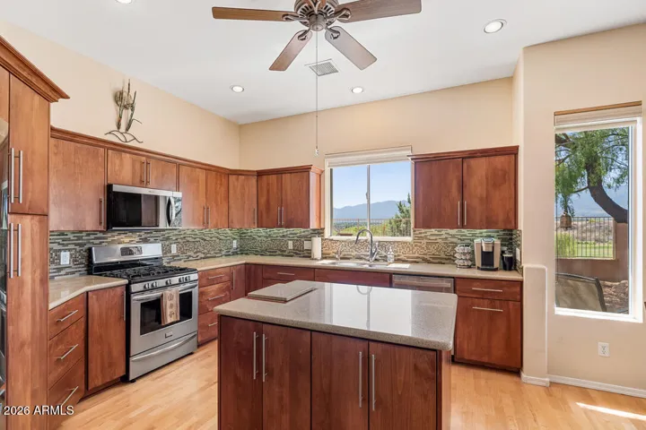 Enjoy views of the golf course and Mingus Mountains right from the sink, complemented by high-end appliances, quartz countertops and thoughtfully upgraded finishes throughout.