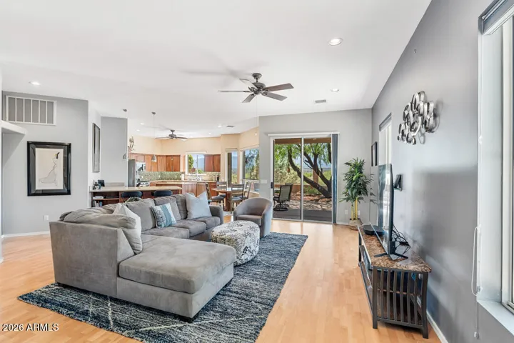 Warm beechwood floors, a ceiling fan, and clean-lined finishes come together to create a space that feels both modern and effortlessly comfortable.