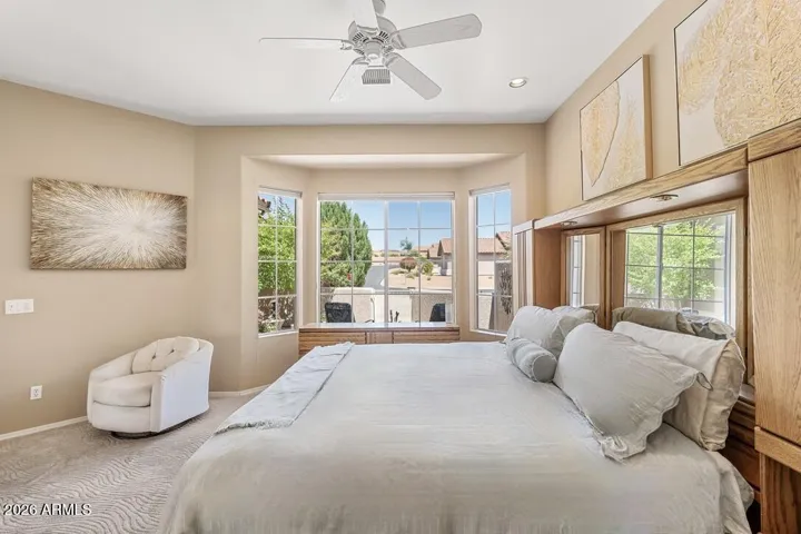 Serenity beckons in this primary suite featuring a beautiful bay window inviting quiet moments and peaceful views.