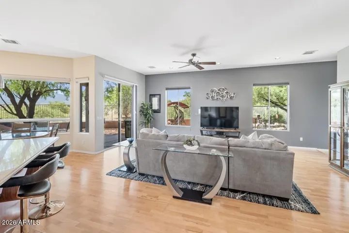 Surrounded by windows, the living room is filled with natural light and lush green outlooks—creating a bright, uplifting connection to the outdoors.
