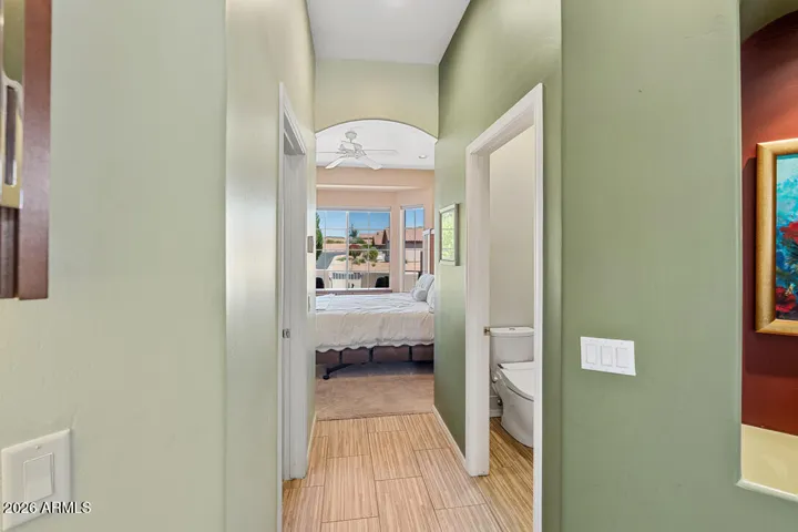 Natural light fills the space, while an expansive walk-in closet designed for wardrobe enthusiasts offers exceptional storage, and a private water closet with bidet is thoughtfully tucked away for added comfort and privacy.