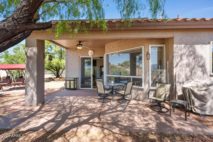 An expansive covered patio ideal for entertaining leads to a generous fenced yard.