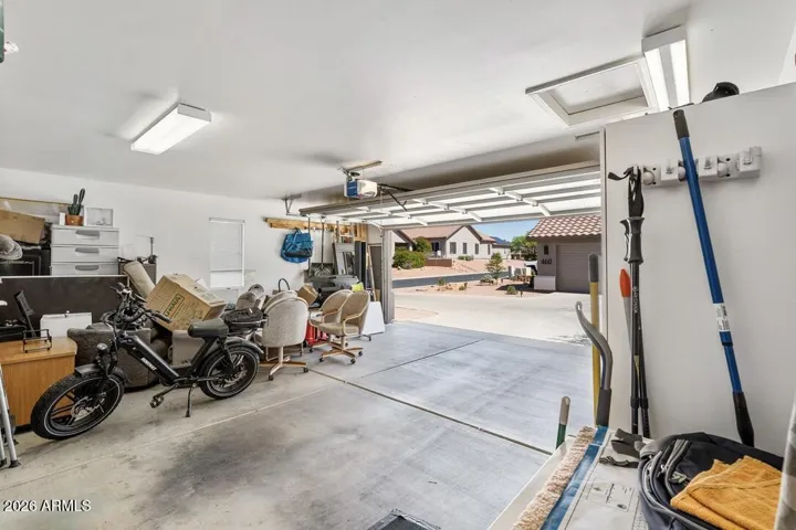 Generous two-car garage with ample room for storage and projects, featuring a utility sink and main electrical panel with whole-house surge protection for added peace of mind.