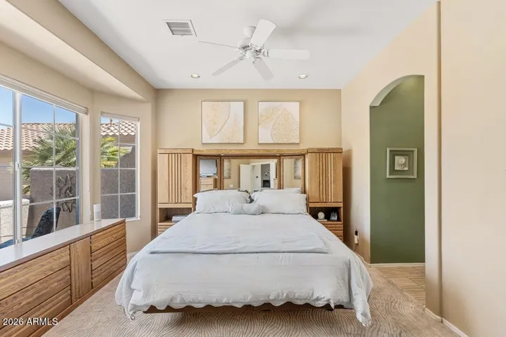 Back inside, the primary suite welcomes you with soaring ceilings, abundant natural light, and soft architectural lines—creating a bright, calming space that feels both open and serene.