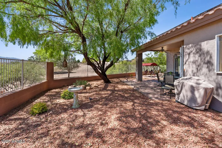Enjoy a fully fenced backyard with shady trees and plenty of space for your pets to roam.