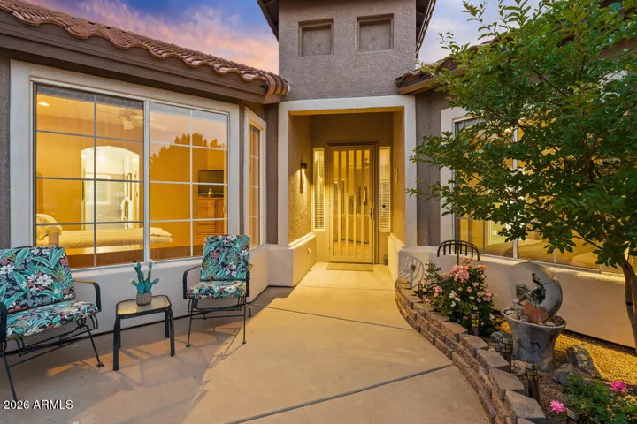 Step through the gated courtyard into a peaceful, light-filled entry—where warmth and a sense of calm set the tone from the very first moment.
