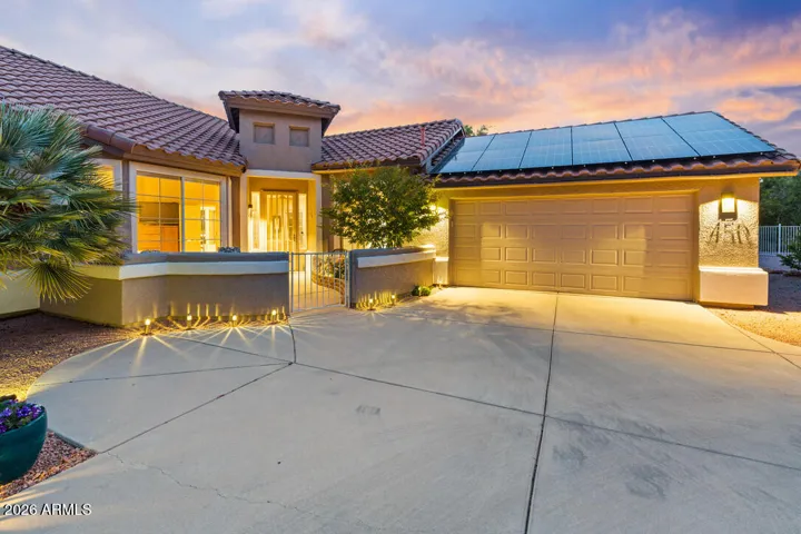Warm exterior lighting and architectural detail create a stunning sense of arrival, where the home glows with comfort and understated elegance.