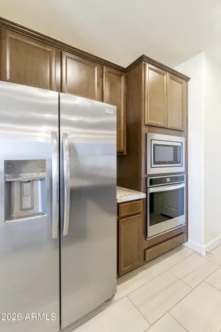Door to the garage is to the right of the oven/microwave.