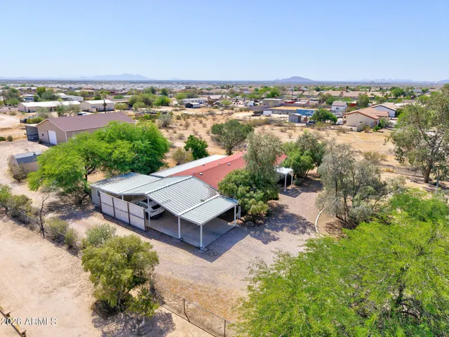 Covered carport parking, home and shop in the back