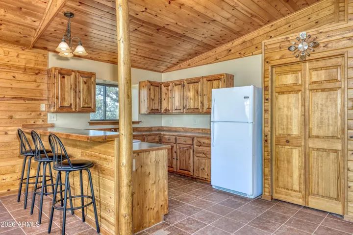 Open Kitchen with Breakfast Bar, Bar Stools. Refrigerator & Stove.