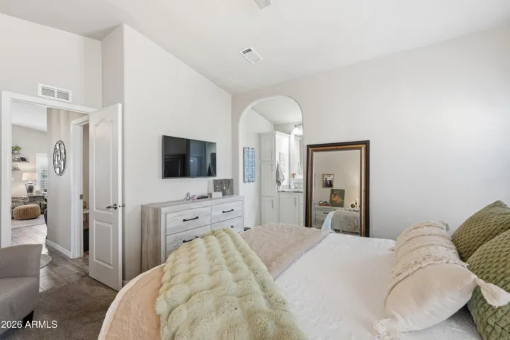 Large primary bedroom with flat screen TV