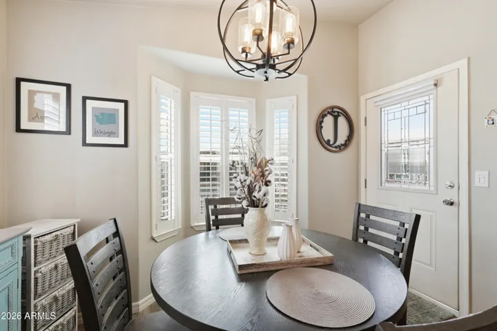 Beautiful dining nook with custom chandelier and bay window
