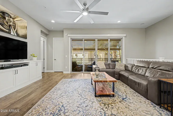 Living room highlighting view of the balcony and pool