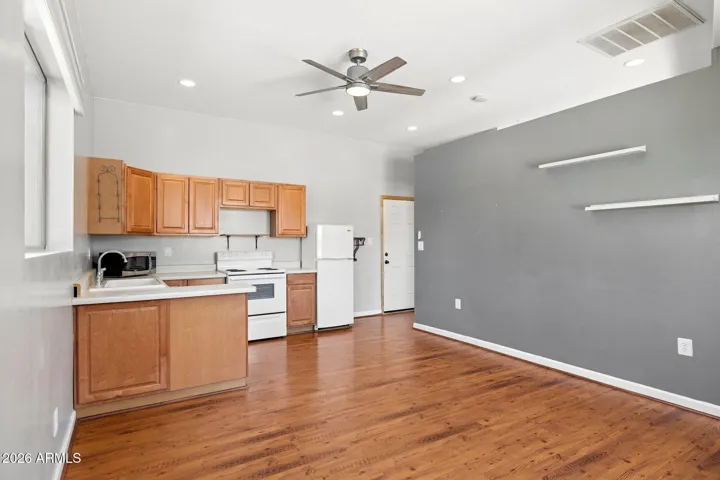 Kitchenette has sink, stove, refrigerator and microwave.