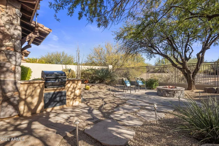 With fire pit, built in BBQ, & spacious covered patio, with no neighbors behind or to the side of property