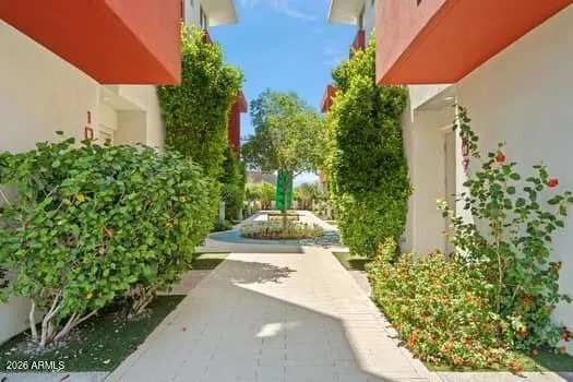 Beautifully maintained community walkway with lush landscaping and a modern urban feel.