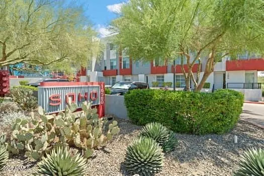 Well-maintained community grounds with desert landscaping, mature trees, and modern exterior details.