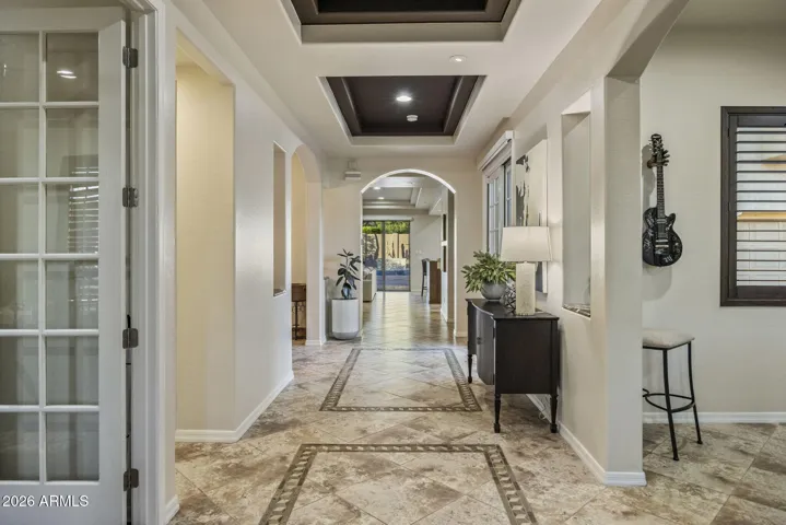The architecture, the rounded walls, arches, coffered ceilings and french doors make this home feel elevated at every turn.