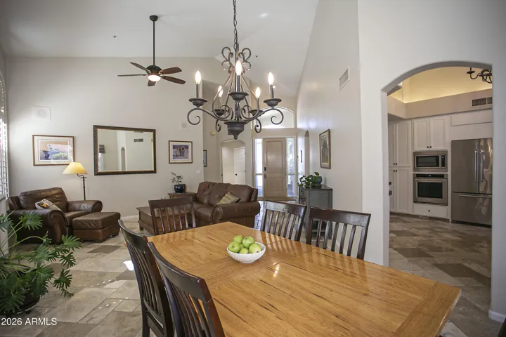 The dining room sits next to the living area with a pass-through to the kitchen, and it also features a patio slider that leads out to the backyard.