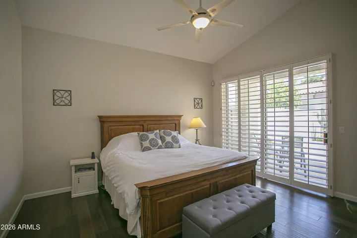 The primary suite offers a private exit to the backyard, where a charming patio awaits.