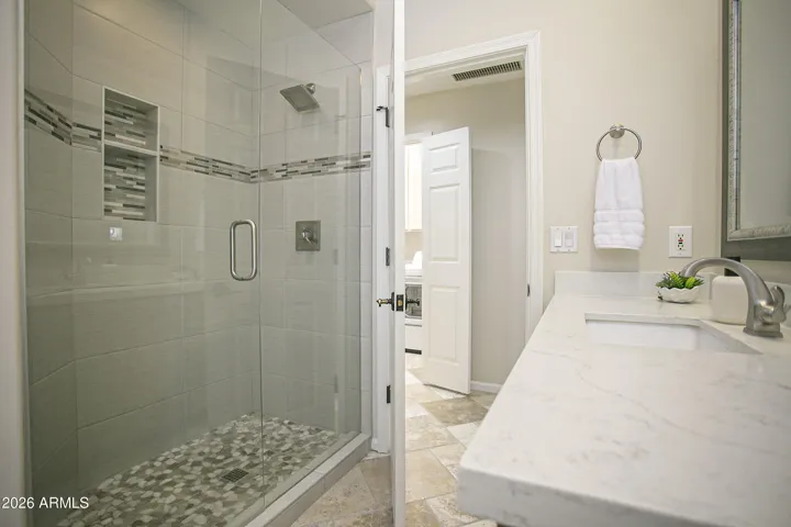 Guest bathroom has been remodeled includes lovely tiled shower with glass doors