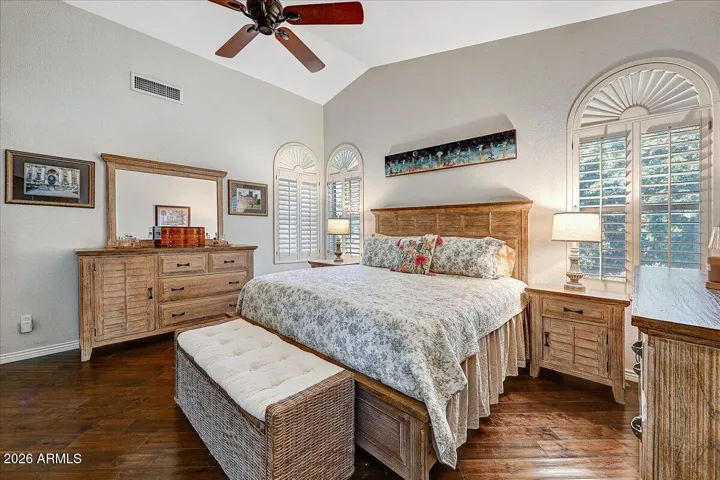Wood floors and sunny windows make the primary suite a special place