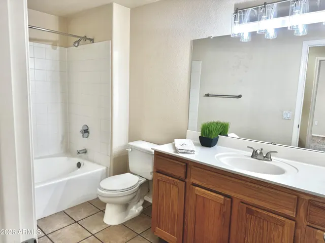 Open bathroom, clean and bright with new light fixture.