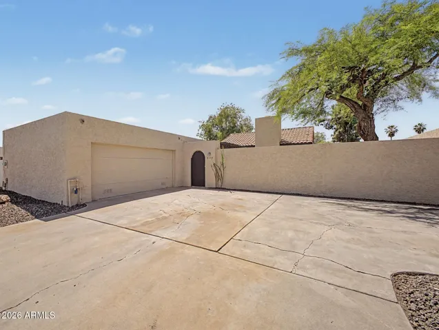 Large driveway and privacy gate to front door entry